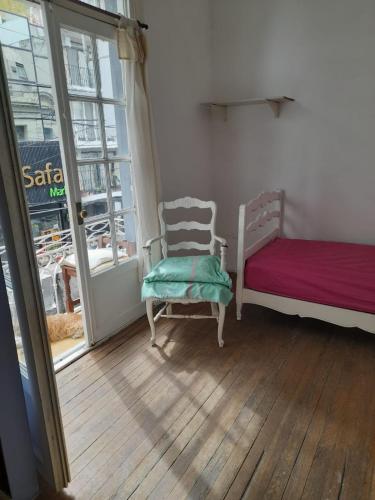 a room with a bed and a chair and a window at Casa de Huéspedes Cristina Recoleta Cristina Guesthouse Recoleta in Buenos Aires
