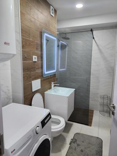 a bathroom with a toilet and a sink and a shower at Daire in Štip