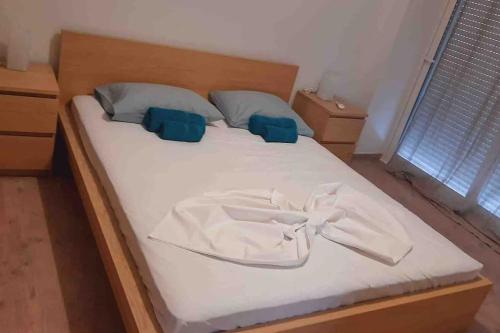 een bed met een witte badjas erop bij Sea View Condo in Chios