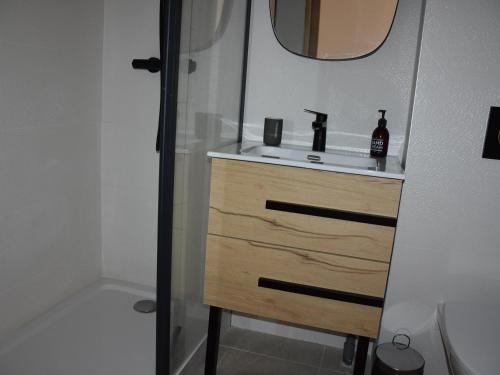 a bathroom with a sink and a mirror at Chalet récent proche centre, piscine et patinoire, avec terrasse et parking couvert - FR-1-464-189 in Pralognan-la-Vanoise