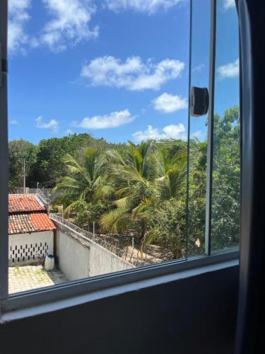 a view from a window of palm trees at Apartamento em Pipa in Pipa