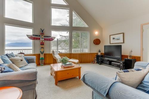 a living room with two couches and a tv at Shoal Bay Luxury Home in Port Stanley