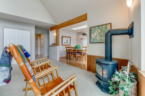 a living room with a stove and a dining room at Shoal Bay Luxury Home in Port Stanley