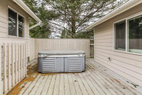 a trash can sitting on a deck outside of a house at Shoal Bay Luxury Home in Port Stanley