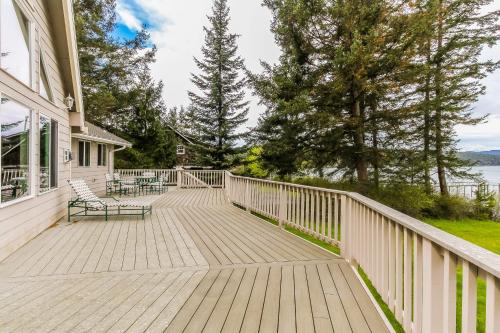 a wooden deck with benches on a house at Shoal Bay Luxury Home in Port Stanley
