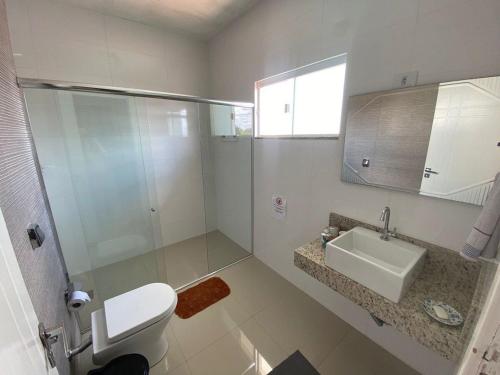 uma casa de banho com um WC, um lavatório e um chuveiro em Estilo e conforto em região central, Foz do Iguaçu em Foz do Iguaçu