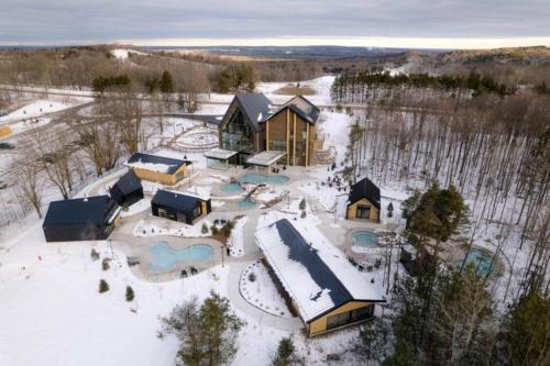 an aerial view of a resort in the snow at Modern Chic Cottage - Hot Tub, Sauna, Tay Trail in Waubaushene