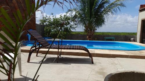 una silla sentada frente a una piscina en Casa L&A, en Aracati