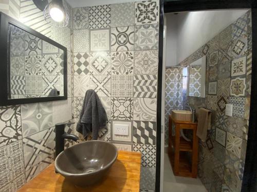 a bathroom with a sink and a tile wall at Casa Nekay in San Lorenzo