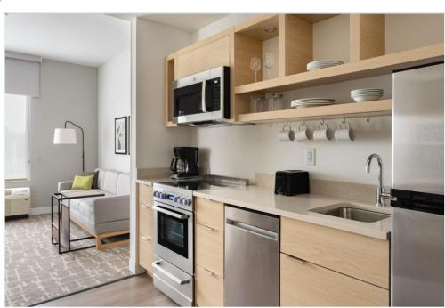a kitchen with a sink and a stove top oven at TownePlace Suites by Marriott Norfolk in Norfolk