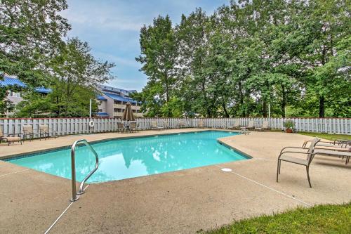 a swimming pool with two chairs and a bench at Lincoln Condo with Resort Amenities and Mountain Views in Lincoln