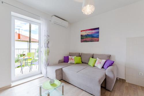 a living room with a couch and a window at Apartment Anamaris in Solin