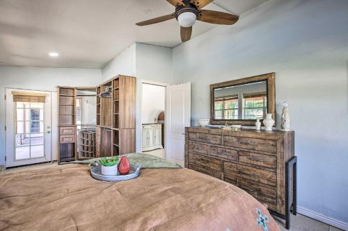 a bedroom with a large bed and a ceiling fan at Spacious Glendale Home with Outdoor Kitchen! in Glendale