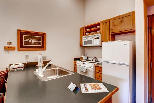 a kitchen with a sink and a refrigerator at Jackpine & Black Bear Condominiums by Keystone Resort in Keystone