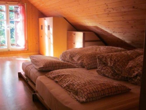 a bedroom with three beds in a attic at Rustico Bersacola in Bosco Gurin