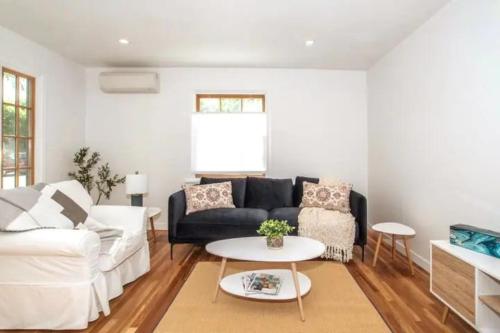 a living room with a couch and a table at North End Bungalow in Boise
