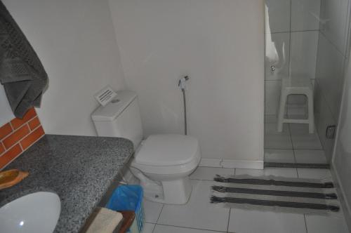 a bathroom with a toilet and a sink and a shower at Villa Cayana in Barra Grande