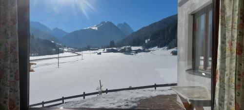 a view from a window of a snow covered field at Ferienhaus Widmann in Kirchberg in Tirol