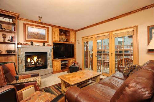 a living room with a couch and a fireplace at Jackpine & Black Bear Condominiums by Keystone Resort in Keystone