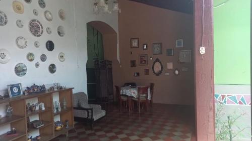 a living room with a table and plates on the wall at Casa Vieja Guest House in Santa Ana