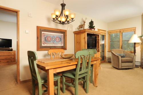 a dining room with a wooden table and chairs at Jackpine & Black Bear Condominiums by Keystone Resort in Keystone