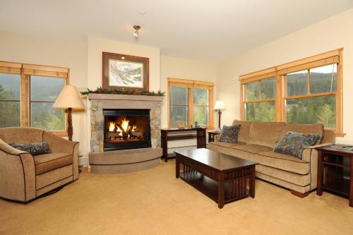 a living room with a fireplace and a couch and chairs at Jackpine & Black Bear Condominiums by Keystone Resort in Keystone