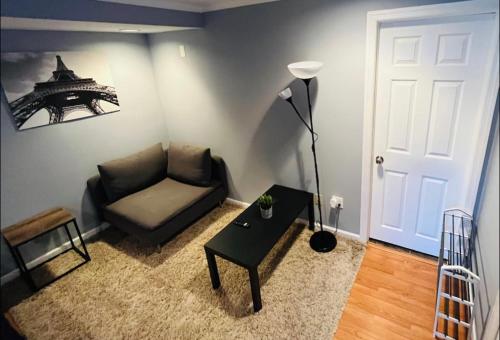 a living room with a couch and a table at Cozy Apartments close to New York City in North Bergen