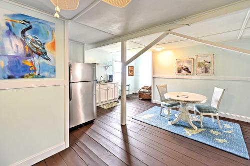 a kitchen with a table and a refrigerator at Historic Swansboro Studio with Intracoastal View! in Swansboro