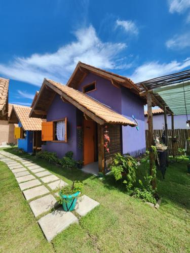 a small house with a blue at Chalés Cabocla da Lua in Caraíva