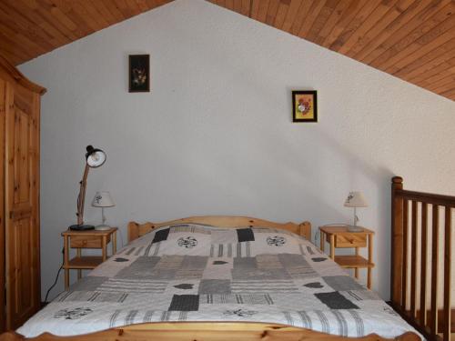 - une chambre avec un lit et 2 tables avec des lampes dans l'établissement Charmant appart avec mezzanine, balcon sud, piscine chauffée, proche pistes et centre - FR-1-464-5, à Pralognan-la-Vanoise