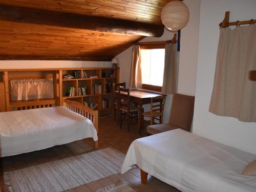 a bedroom with two beds and a table and a desk at Chalet Pralognan-la-Vanoise, 7 pièces, 12 personnes - FR-1-464-11 in Pralognan-la-Vanoise