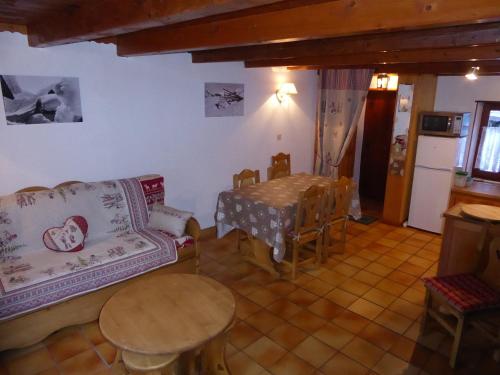 a living room with a couch and a table at Charmant Chalet en Pierre et Bois à Pralognan-la-Vanoise, Proche Commerces et Téléphérique - FR-1-464-16 in Pralognan-la-Vanoise