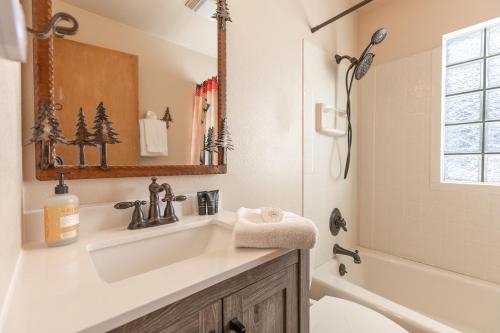 a bathroom with a sink and a tub and a shower at The Fishermans Place Peaceful with Mountain Views in Breckenridge