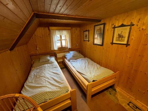 A bed or beds in a room at Chalupa Skalka