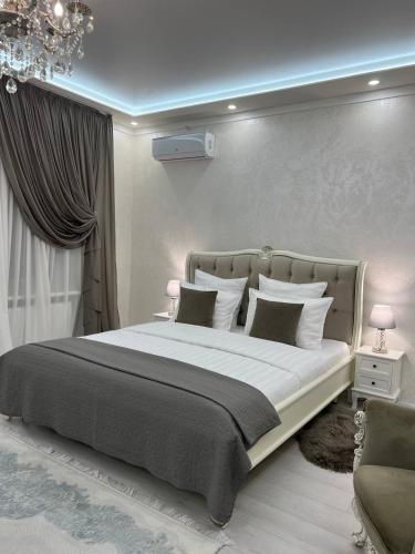 a bedroom with a large bed and a chandelier at Sobor in Vinnytsya