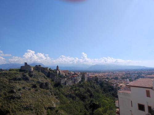 a view of a city with a castle on a hill at Mila Prestigioso Appartamento in Scalea
