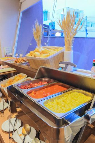 a buffet line with many different types of food at i5 Hotel Águas Claras in Brasilia
