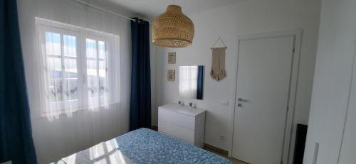 a bedroom with a bed and a dresser and a window at Sull'Onda in Scalea