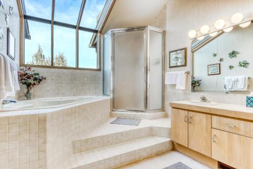 a bathroom with a tub and a shower and a sink at Robin Court Retreat in Redmond