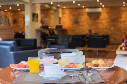 a table with a tray of breakfast foods and drinks at i5 Hotel Águas Claras in Brasilia