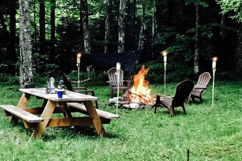a picnic table and chairs next to a fire at Little Red in Wilmington