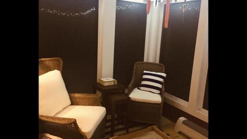 a living room with two chairs and a window at Little Red in Wilmington