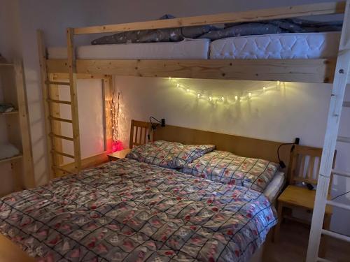 a bedroom with two bunk beds with a comforter at Apartmán Meluzína in Staré Hamry