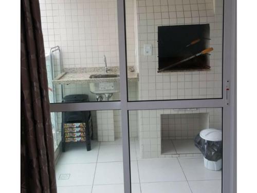 a view of a bathroom with a sink and a mirror at Apartamento Aconchegante in Ubatuba