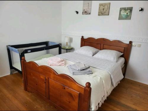 a bedroom with a wooden bed with a wooden floor at rêvedelac meublé tout confort in Brêmes