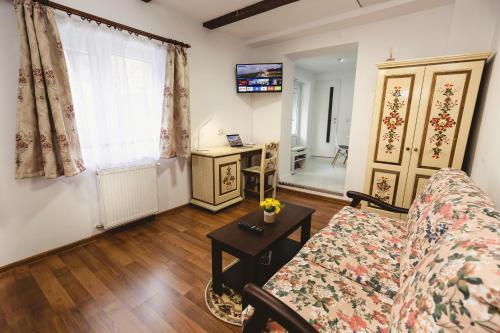 a living room with a couch and a table at The Transylvanian Apartment - near Bridge ofLies in Sibiu