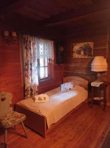 a bedroom with a bed and a window at Siedlisko Lubicz Stara Chata Kazimierz Dolny in Kazimierz Dolny