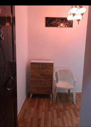 a room with a dresser and a chair and a cabinet at Lovely 2 bedroom vacation rental unit in Yalova