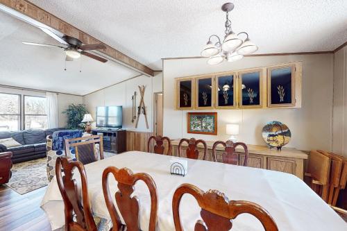 a dining room and living room with a table and chairs at Yatahey in South Fork