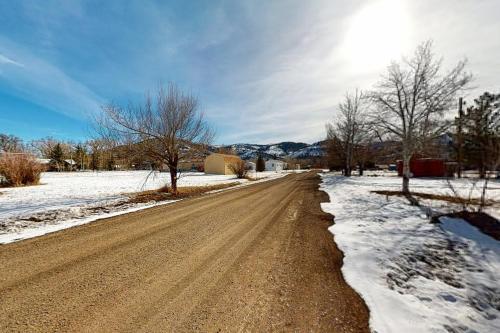 a dirt road with snow on the side of it at Yatahey in South Fork